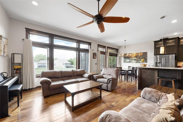302 6th St NE, Mount Vernon, IA 52314 - living room featuring a ceiling fan, recessed lighting, and light wood-style flooring