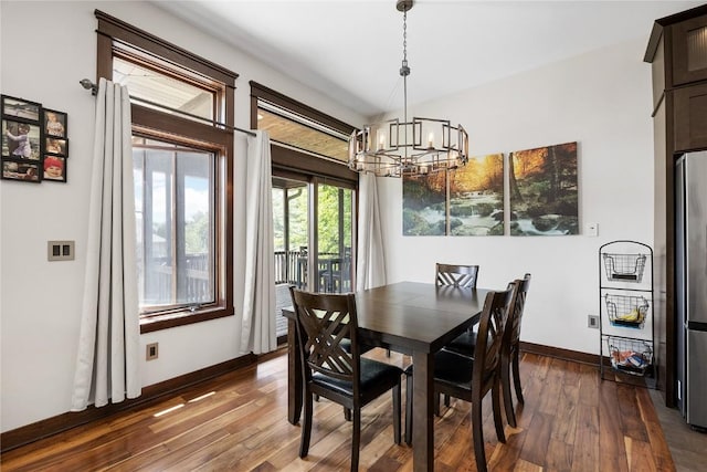 302 6th St NE, Mount Vernon, IA 52314 - dining room featuring a chandelier, dark wood-type flooring, and baseboards
