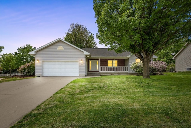 1451 Chamberlain Dr, Iowa City, IA 52240 - single story home with an attached garage, covered porch, concrete driveway, and a yard