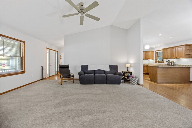 1451 Chamberlain Dr, Iowa City, IA 52240 - living area with light carpet, ceiling fan, baseboards, lofted ceiling, and recessed lighting