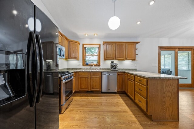 1451 Chamberlain Dr, Iowa City, IA 52240 - kitchen featuring stainless steel appliances, a peninsula, a sink, light wood-style flooring, and recessed lighting
