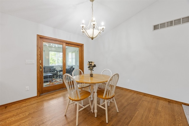 1451 Chamberlain Dr, Iowa City, IA 52240 - dining room featuring a chandelier, light wood-type flooring, and baseboards
