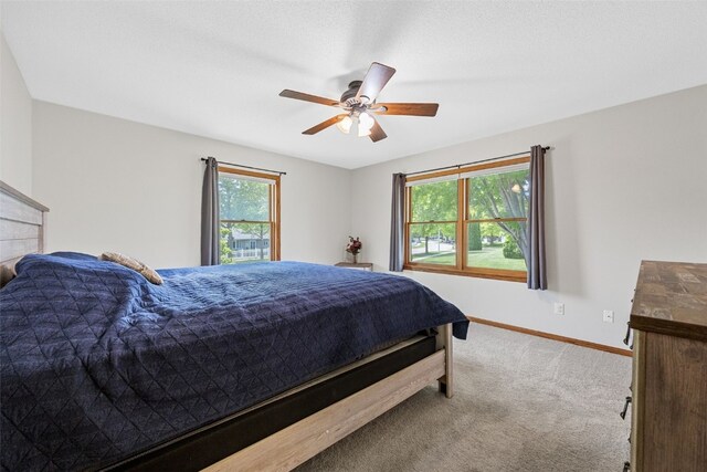 1451 Chamberlain Dr, Iowa City, IA 52240 - bedroom with carpet flooring, baseboards, and a ceiling fan