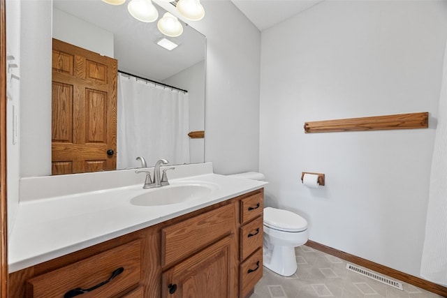 1451 Chamberlain Dr, Iowa City, IA 52240 - bathroom featuring toilet, baseboards, and vanity