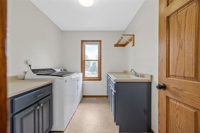 1451 Chamberlain Dr, Iowa City, IA 52240 - clothes washing area featuring washer and clothes dryer, cabinet space, and baseboards