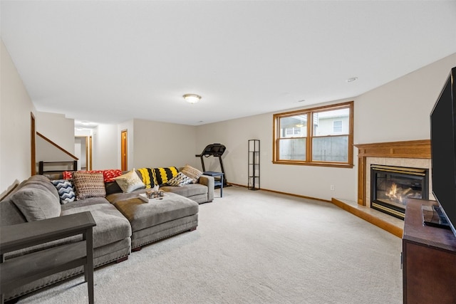 1451 Chamberlain Dr, Iowa City, IA 52240 - living area with light carpet, a glass covered fireplace, stairs, and baseboards