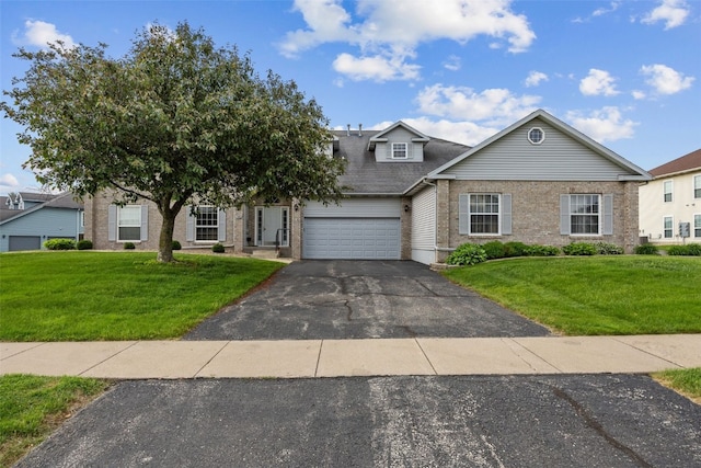3445 Willowridge Rd Unit B, Marion, IA 52302 - view of front facade featuring an attached garage, asphalt driveway, brick siding, and a front lawn