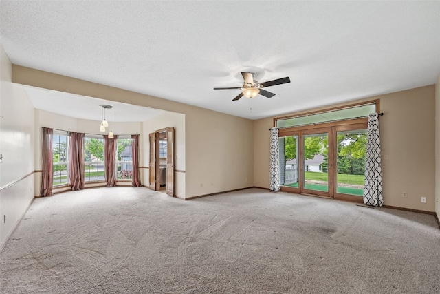 3445 Willowridge Rd Unit B, Marion, IA 52302 - carpeted empty room with plenty of natural light, baseboards, and ceiling fan