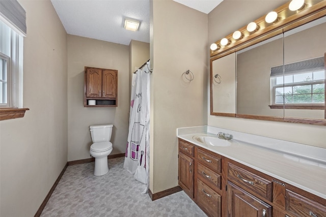 3445 Willowridge Rd Unit B, Marion, IA 52302 - bathroom featuring tile patterned floors, baseboards, vanity, and toilet