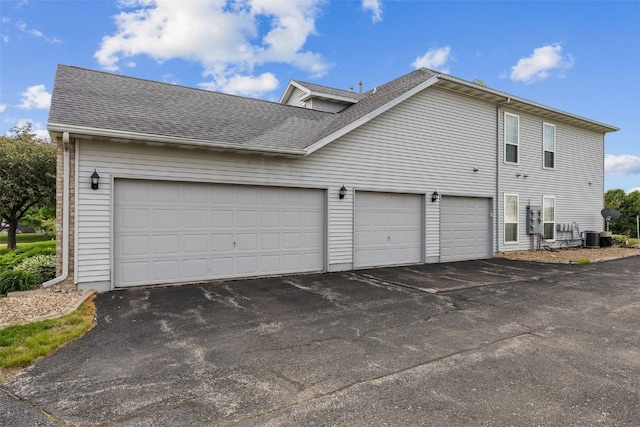 3445 Willowridge Rd Unit B, Marion, IA 52302 - view of side of property with driveway, central AC, and a shingled roof