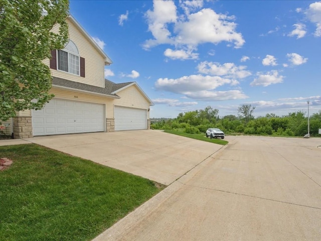3626 Stoneview Cir SW, Cedar Rapids, IA 52404 - view of side of property featuring driveway and stone siding