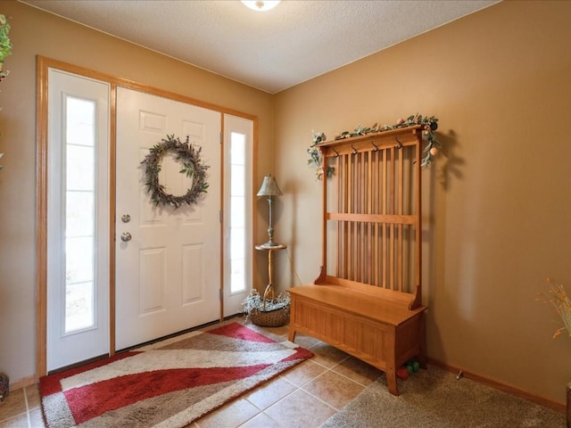 3626 Stoneview Cir SW, Cedar Rapids, IA 52404 - foyer featuring healthy amount of natural light, baseboards, tile patterned floors, and a textured ceiling