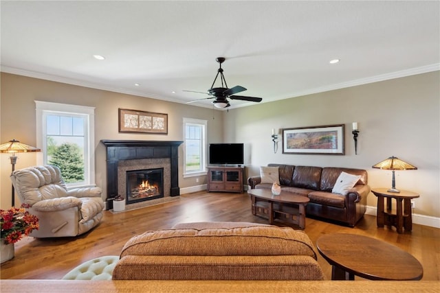 1443 69th St, Keystone, IA 52249 - living area with crown molding, a fireplace with flush hearth, wood finished floors, recessed lighting, and ceiling fan