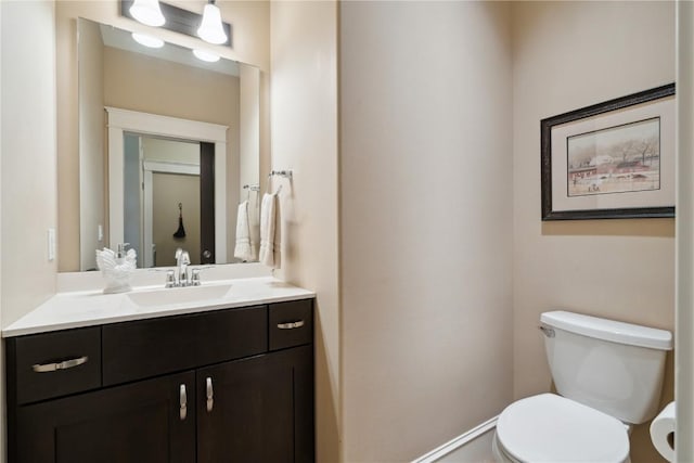 1443 69th St, Keystone, IA 52249 - bathroom featuring toilet, vanity, and baseboards