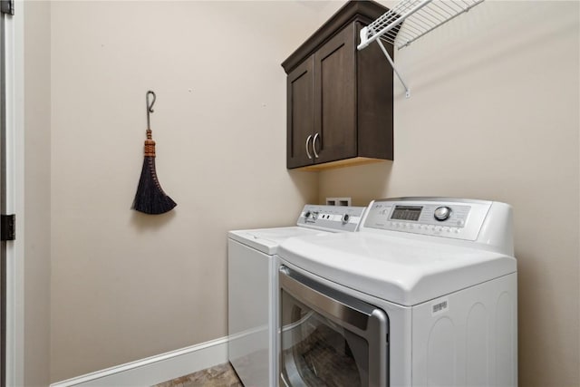 1443 69th St, Keystone, IA 52249 - laundry room featuring washer and clothes dryer, cabinet space, and baseboards