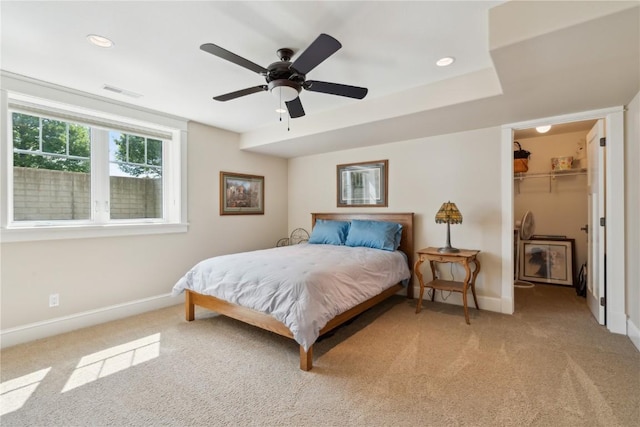 1443 69th St, Keystone, IA 52249 - bedroom featuring baseboards, light colored carpet, a walk in closet, a ceiling fan, and a closet