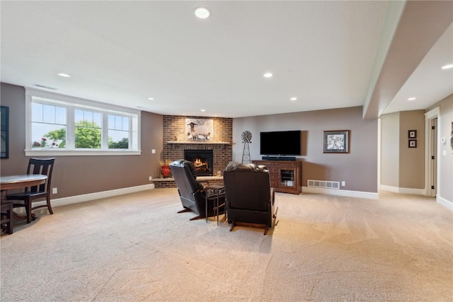1443 69th St, Keystone, IA 52249 - living area with a brick fireplace, light carpet, recessed lighting, and baseboards