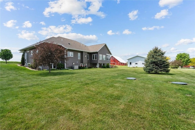 1443 69th St, Keystone, IA 52249 - back of house featuring a lawn and central air condition unit