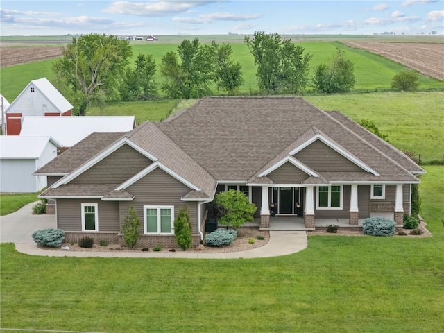 1443 69th St, Keystone, IA 52249 - craftsman inspired home featuring a front yard, a shingled roof, a rural view, and brick siding