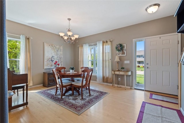 3205 Lennon Ln, Marion, IA 52302 - dining space with a chandelier, healthy amount of natural light, and light wood-style flooring