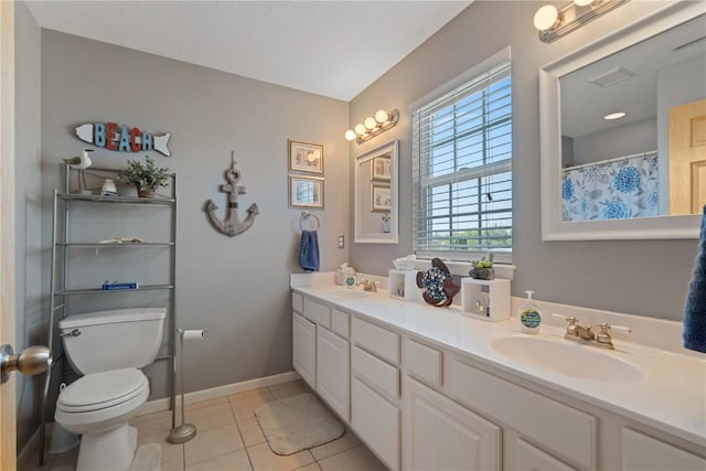 3205 Lennon Ln, Marion, IA 52302 - bathroom featuring toilet, tile patterned floors, double vanity, and baseboards