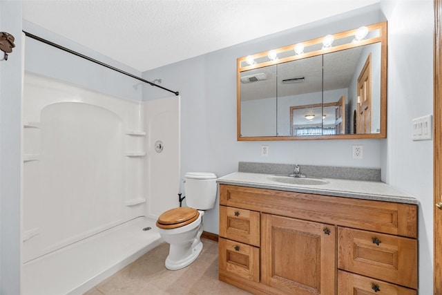 bathroom featuring a shower, toilet, vanity, tile patterned floors, and a textured ceiling