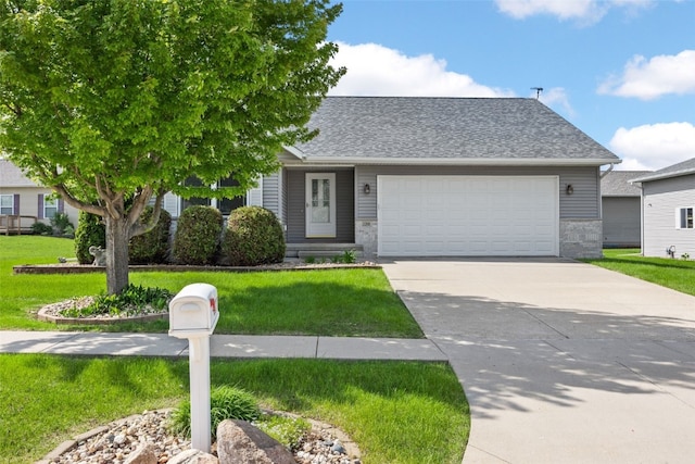 view of front of home featuring a front lawn, driveway, an attached garage, and roof with shingles