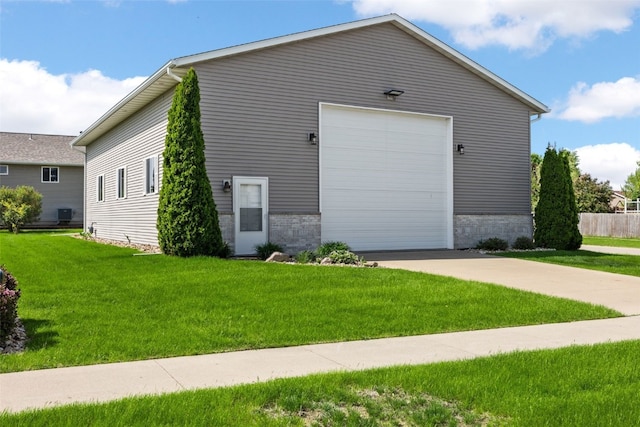view of side of home featuring a yard and driveway