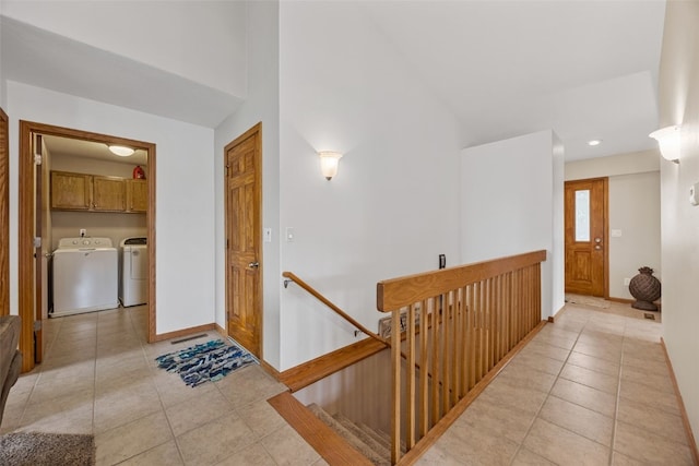 hall with an upstairs landing, light tile patterned floors, washer and dryer, baseboards, and recessed lighting