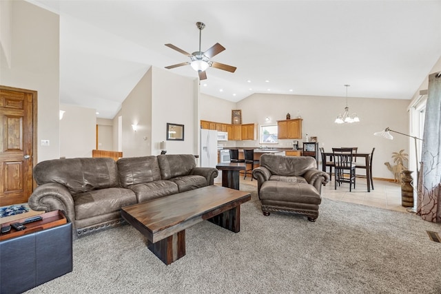 living room featuring a ceiling fan, a chandelier, healthy amount of natural light, high vaulted ceiling, and light carpet