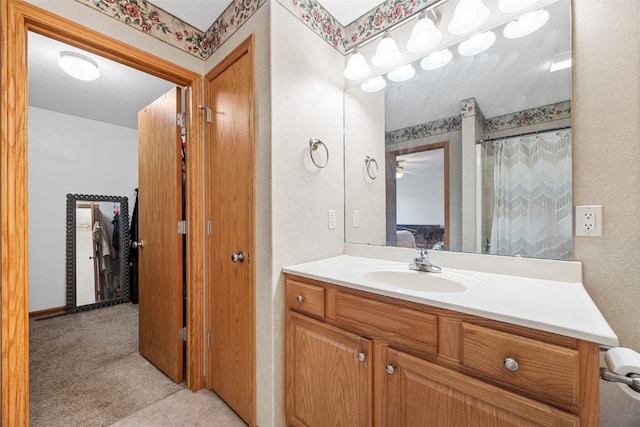 full bath with vanity and ceiling fan