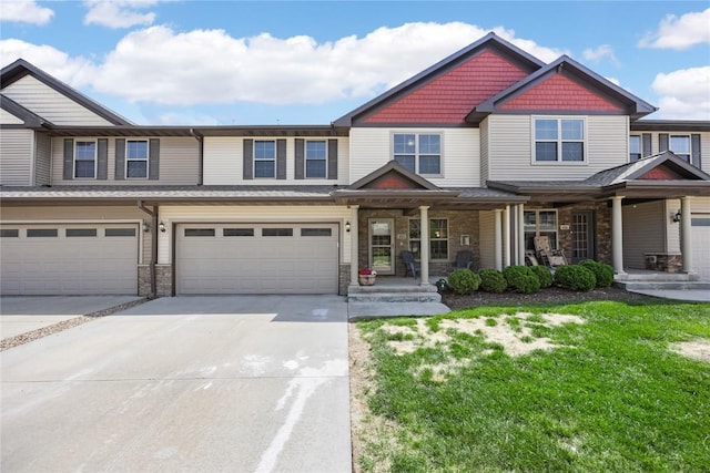 414 Churchill Dr, North Liberty, IA 52317 - multi unit property with concrete driveway, covered porch, and stone siding