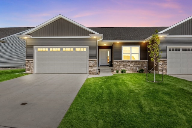 424 15th Ave SW, Mount Vernon, IA 52314 - view of front of property with an attached garage, concrete driveway, stone siding, a front yard, and board and batten siding