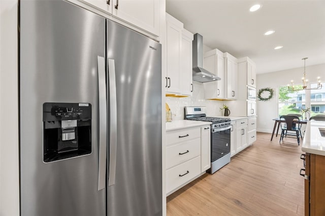 424 15th Ave SW, Mount Vernon, IA 52314 - kitchen with appliances with stainless steel finishes, wall chimney exhaust hood, white cabinets, light countertops, and recessed lighting