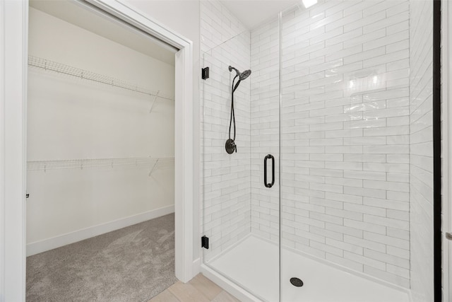 424 15th Ave SW, Mount Vernon, IA 52314 - full bath with a shower stall, a spacious closet, and baseboards