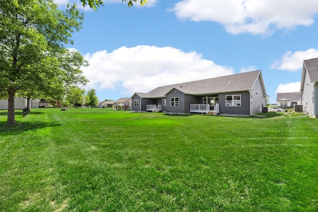 424 15th Ave SW, Mount Vernon, IA 52314 - rear view of house featuring a wooden deck, a lawn, and cooling unit