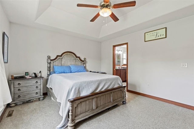 395 Carlyle Dr, North Liberty, IA 52317 - bedroom with a tray ceiling, carpet flooring, baseboards, ensuite bath, and a ceiling fan
