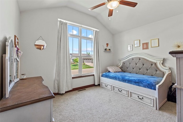 395 Carlyle Dr, North Liberty, IA 52317 - carpeted bedroom with vaulted ceiling, multiple windows, ceiling fan, and baseboards
