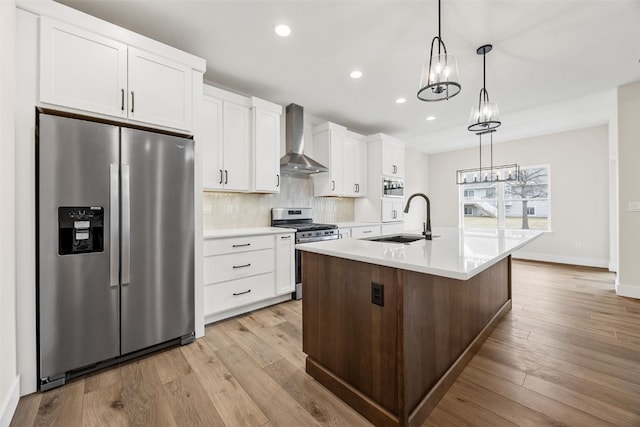 430 15th Ave SW, Mount Vernon, IA 52314 - kitchen featuring stainless steel appliances, a sink, wall chimney range hood, white cabinetry, and recessed lighting