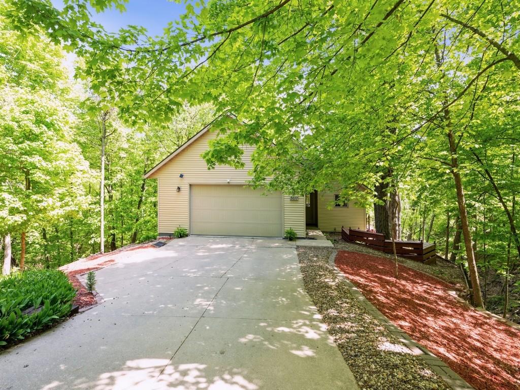 obstructed view of property featuring driveway and a garage