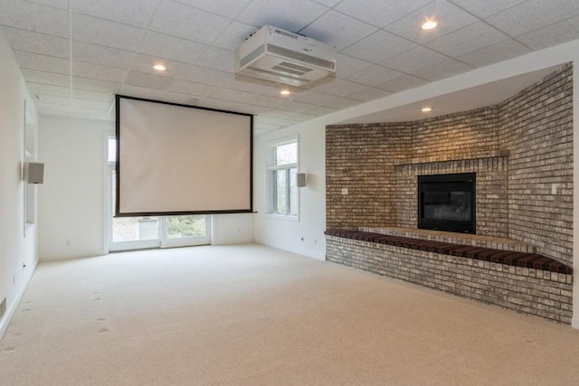 3120 Cottage Grove Ave SE, Cedar Rapids, IA 52403 - carpeted home theater room featuring a brick fireplace, a paneled ceiling, brick wall, and recessed lighting