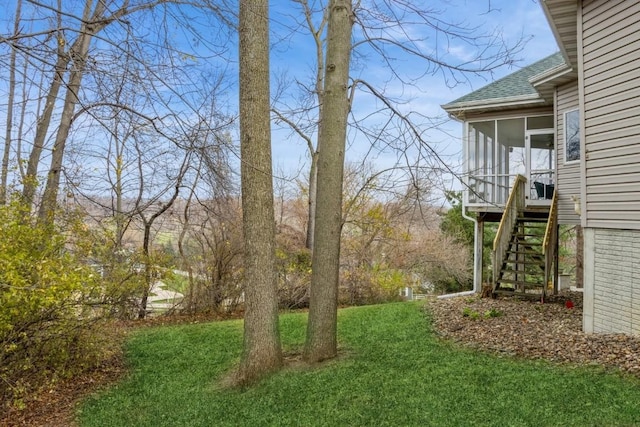 3120 Cottage Grove Ave SE, Cedar Rapids, IA 52403 - view of grassy yard featuring stairway and a sunroom
