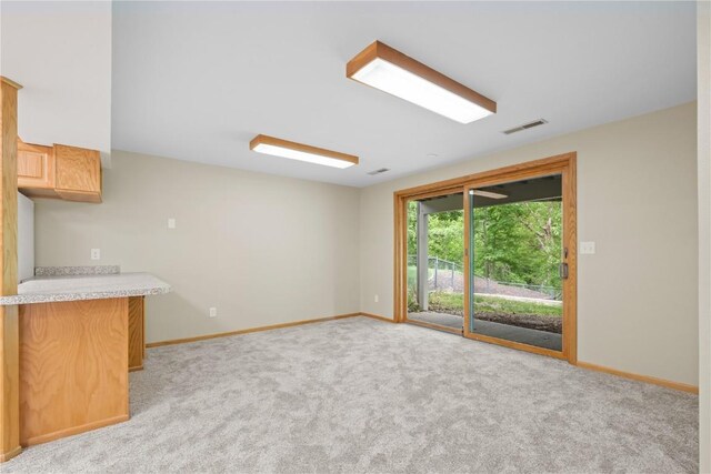 942 Evergreen Ct, Iowa City, IA 52245 - unfurnished living room with light carpet and baseboards
