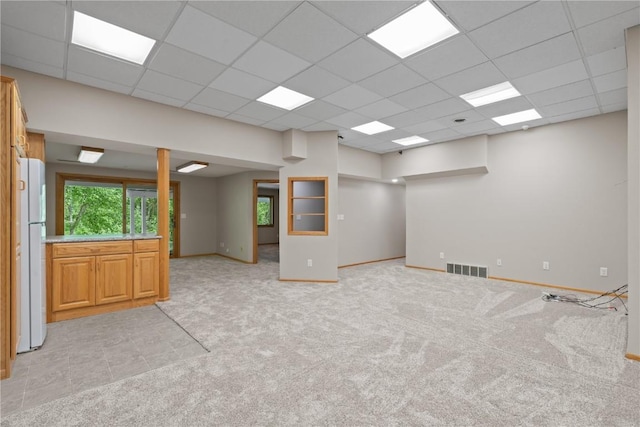 942 Evergreen Ct, Iowa City, IA 52245 - spare room featuring light colored carpet, a paneled ceiling, and baseboards