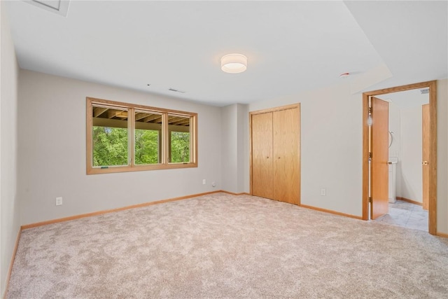 942 Evergreen Ct, Iowa City, IA 52245 - unfurnished bedroom featuring carpet, baseboards, and a closet