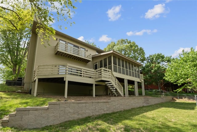 942 Evergreen Ct, Iowa City, IA 52245 - back of property with a sunroom, a wooden deck, and stairway