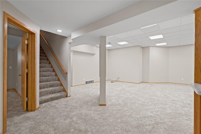 942 Evergreen Ct, Iowa City, IA 52245 - finished below grade area featuring carpet, stairway, baseboards, and a paneled ceiling
