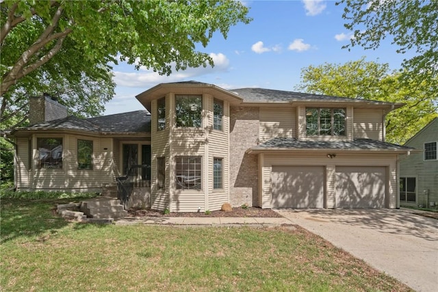 942 Evergreen Ct, Iowa City, IA 52245 - view of front of home featuring driveway, a garage, a front yard, and a chimney
