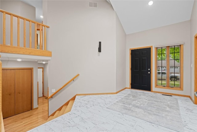 942 Evergreen Ct, Iowa City, IA 52245 - entrance foyer with marble finish flooring, a high ceiling, baseboards, stairs, and recessed lighting
