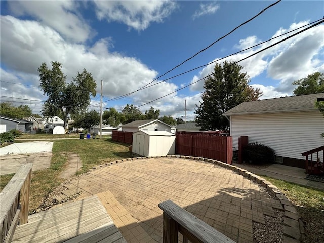 1338 22nd Ave SW, Cedar Rapids, IA 52404 - view of patio / terrace featuring a storage unit, an outbuilding, and fence